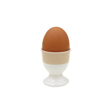 Chicken eggs placed in ceramic cups on white background