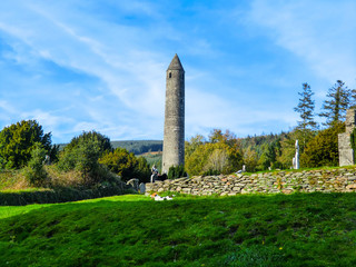 Fototapeta na wymiar DUBLIN, Round Tower and Graveyard in Glendalough Early Monastic Site, County Wicklow, Ireland, Europe