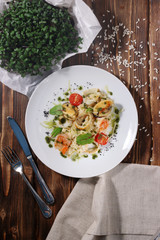risotto with seafood top view with cutlery and greene