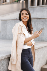 Pretty young woman using mobile phone