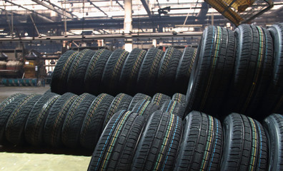New vehicle tires stacked in production workshop at the tires factory 
