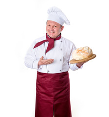 Happy chef chef holds a loaf of fresh bread. Cooking is delicious.
