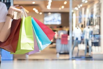 Closeup of woman holding shopping colorful of shopping bags at shopping mall with copy space -...