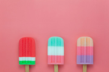 Table top view aerial image of food for summer holiday background concept.Flat lay variety ice cream pop stick on modern rustic pink paper wallpaper.Space for creative design for add text and content.