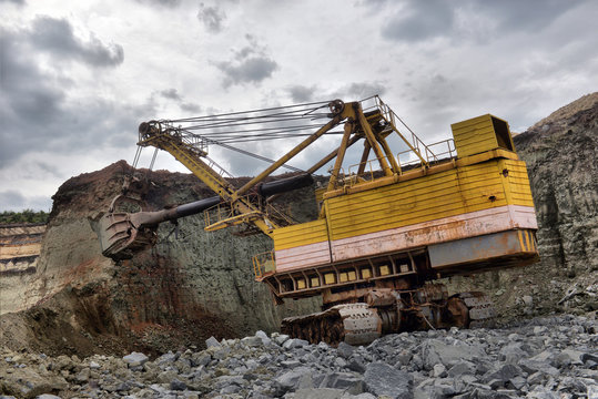 excavator works with granite or ore at opencast mining