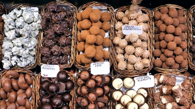 Dolly shot over Chocolate pralines display at La Boqueria market, Barcelona.