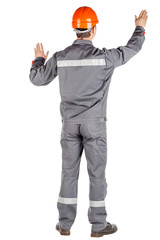 Full length portrait of a male builder in a helmet looking at camera over white wall background. repair, construction, building, people and maintenance concept.