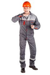 Full length portrait of a male builder in a helmet looking at camera over white wall background. repair, construction, building, people and maintenance concept.