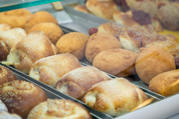 Trays with typical Sicilian street food: arancine, rosticceria