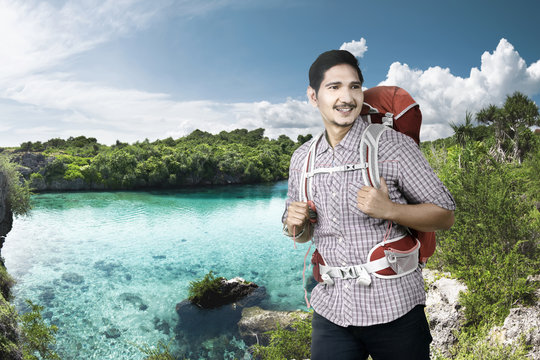Cheerful asian backpacker enjoying nature