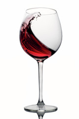 moving red wine glass over a white background