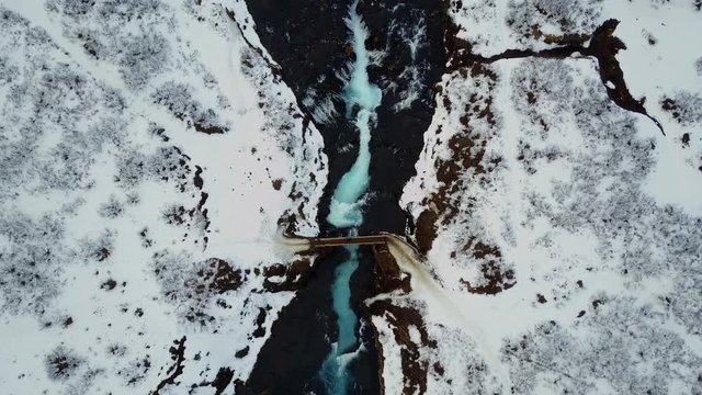 4K. Aerial view over Bruarfoss waterfall. Flowing of turquoise water and surrounded by fresh snow of winter. famous destination in South Iceland
