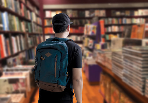 learning and education concept  student go to ibrary bookshelves on background