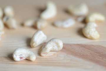 Fototapeta na wymiar Cashew nuts on a wooden background close up