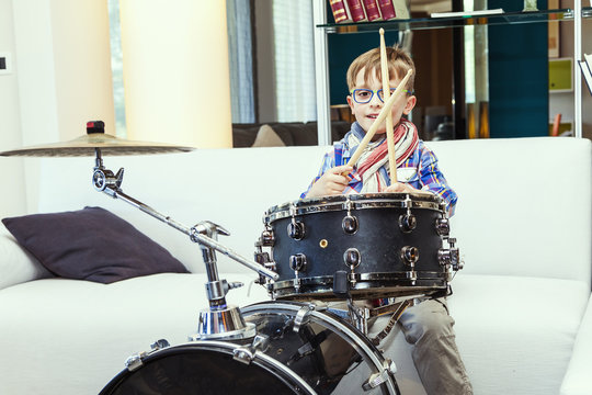 prodigy child plays the drums at home