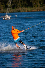 Wakeboarder  is training in a cable park