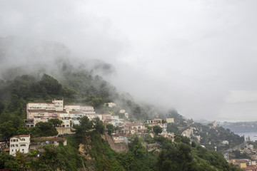 The fog descended on a mountain village. Rain.