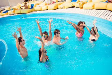 International season cool relationship youth seaside teenagers luxury spa sunshine glasses concept. Six rejoicing funny amusing entertaining glad excited people making splashes in blue clear pool