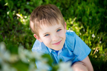 portrait of a boy with blue eyes. The boy in the park. Lovely preschooler in summer on vacation. Children's Day - June 1. beginning of summer holidays
