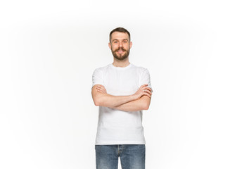 Fototapeta premium Closeup of young man's body in empty white t-shirt isolated on white background. Mock up for disign concept