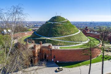 Kosciuszko Mound (Kopiec Kościuszki). Krakow landmark, Poland. Erected in 1823 to commemorate Tadeusz Kosciuszko. Surrounded by a citadel built by Austrian Administration about 1850. Aerial view - obrazy, fototapety, plakaty