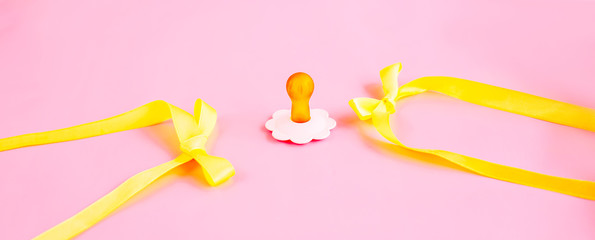 pacifier, soother on pink background