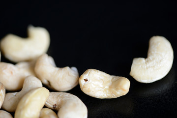 Cashew nuts on a dark background close up