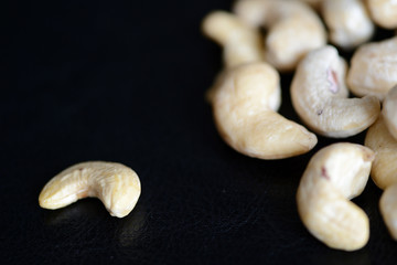 Cashew nuts on a dark background close up