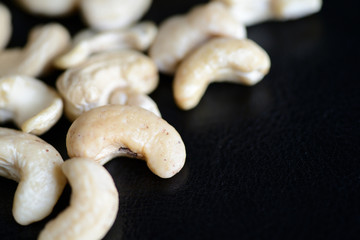 Cashew nuts on a dark background close up