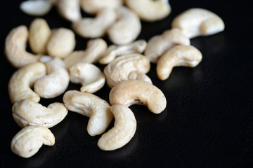 Cashew nuts on a dark background close up