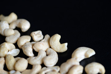 Cashew nuts on a dark background close up