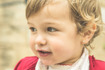 Portrait of a little blonde girl smiling