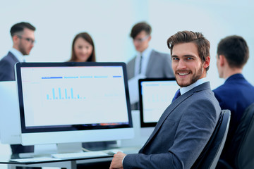 Businessman analyzing economic graphs at office