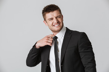 Portrait of an annoyed young businessman in suit