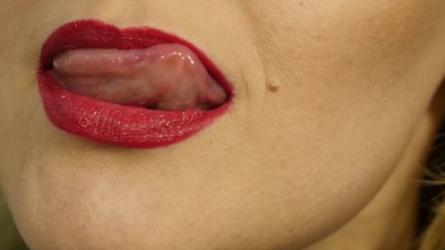 Extreme close up of sexy lip. Woman pursing her lips in a sexy seductive gesture. slow motion