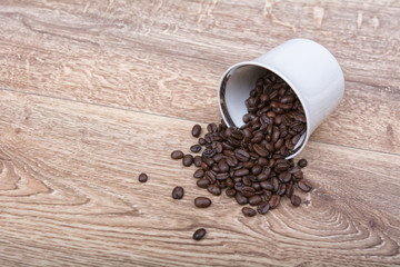 Coffee spill out of a white cup on table