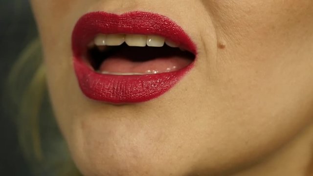 Extreme close up of sexy lip. Woman pursing her lips in a sexy seductive gesture. slow motion
