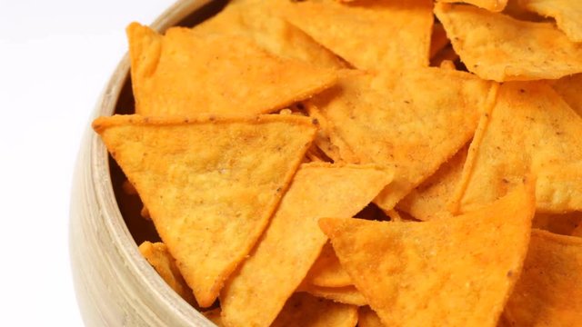 Close up of rotating nacho chips in bowl. No sound.