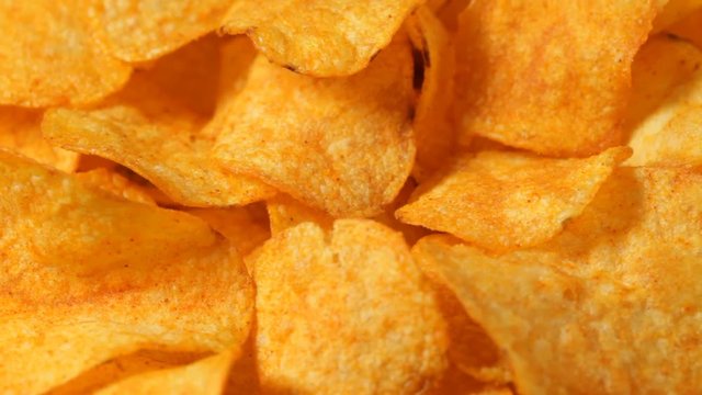 Close up of rotating paprika potato chips. No sound.