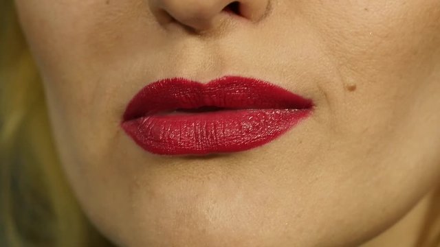Extreme close up of sexy lip. Woman pursing her lips in a sexy seductive gesture. slow motion