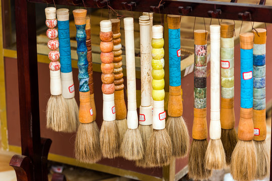 Souvenir brushes with precious stones, Luang Prabang, Laos. Close-up.