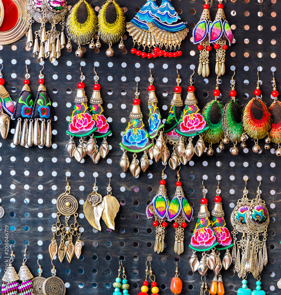 Wall mural Colorful decoration for sale. Earrings handmade, Luang Prabang, Laos. Close-up.