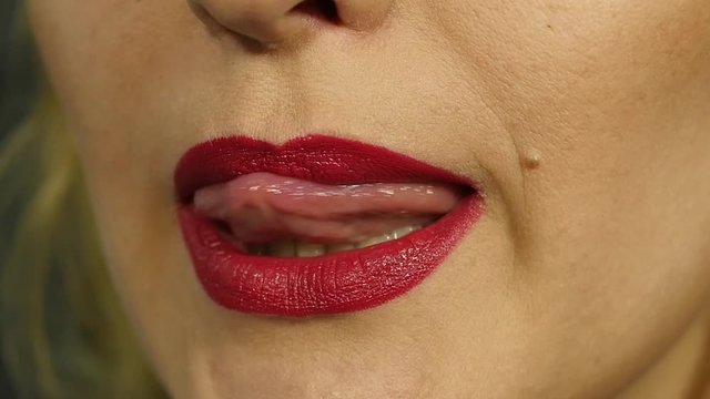 Extreme close up of sexy lip. Woman pursing her lips in a sexy seductive gesture. slow motion