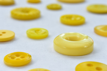 yellow sewing buttons on white