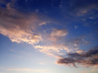 Naklejka na ściany i meble Evening sunset light on clouds