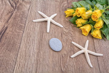 Concept of starfish and tulips on a table