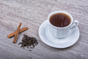 Obraz na płótnie Canvas A cup of tea with cinnamon on a table