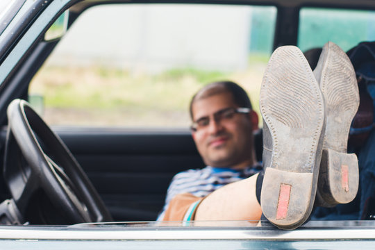 Man With Glasses Resting In The Car