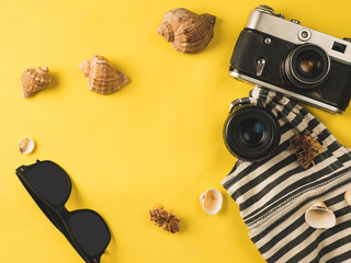 Flat lay traveler accessories on yellow background with blank space for text. The concept of relaxing on vacation