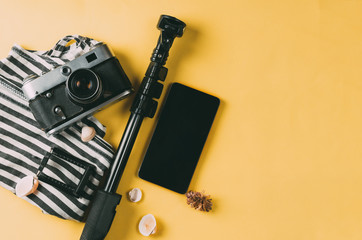 Fototapeta premium Flat lay traveler accessories on yellow background with blank space for text. The concept of relaxing on vacation